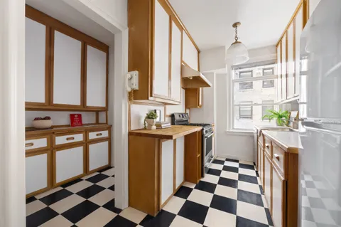 a kitchen with stainless steel appliances a refrigerator and a stove top oven