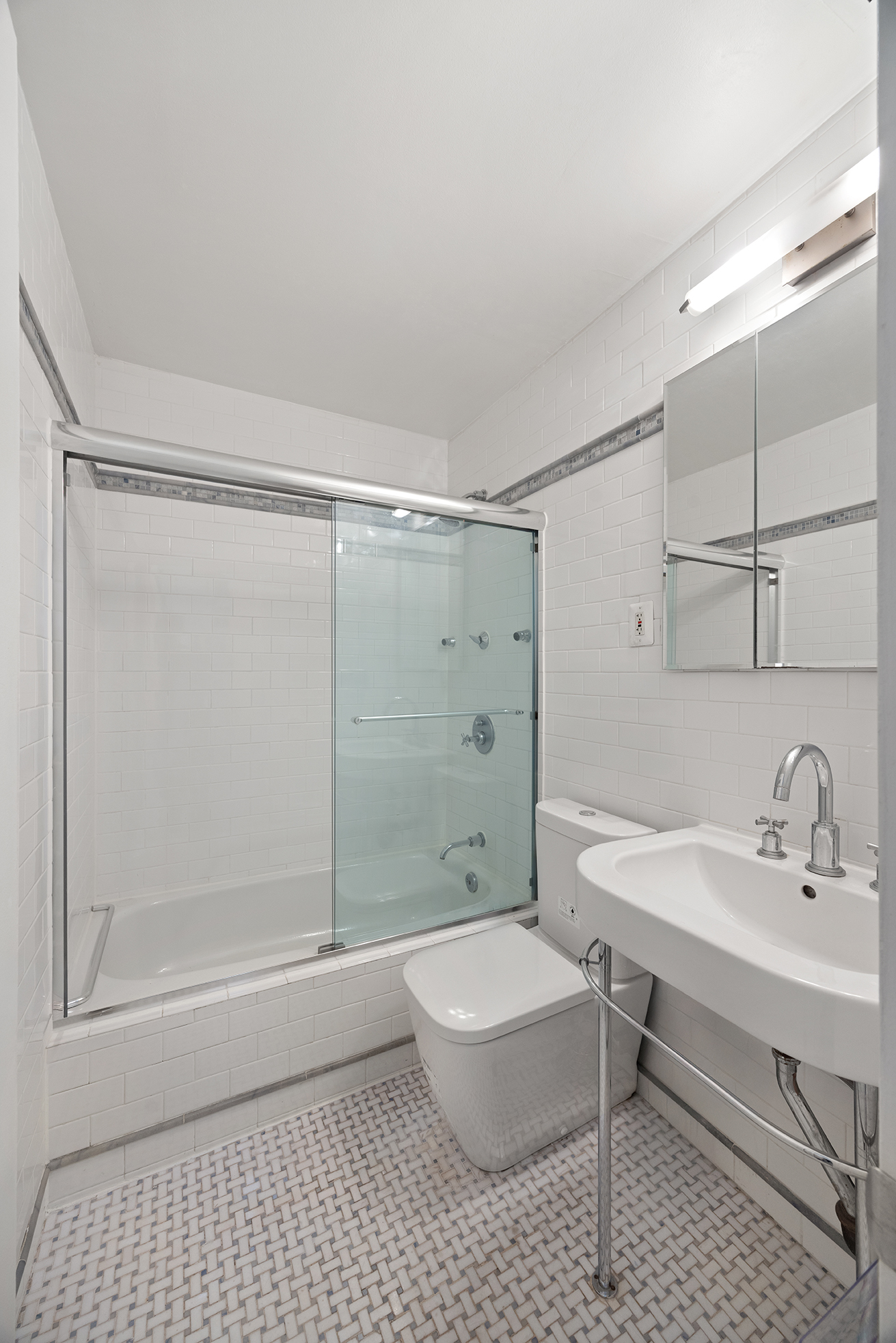 250 Mercer Street, Unit C414 Manhattan, NY 10012 - Photo 9 of 14 a bathroom with a sink toilet and shower