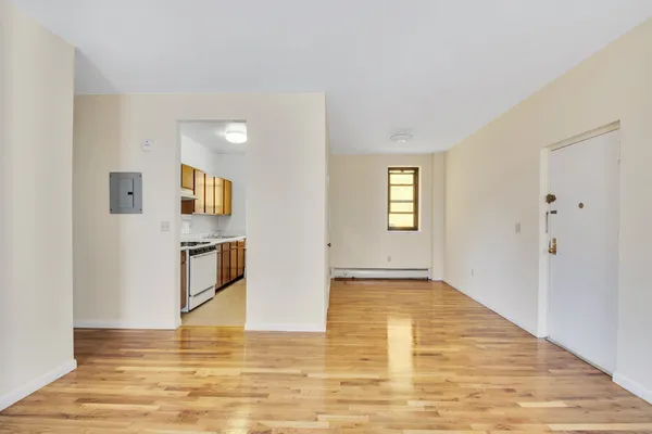 a view of a living room with furniture wooden floor and window