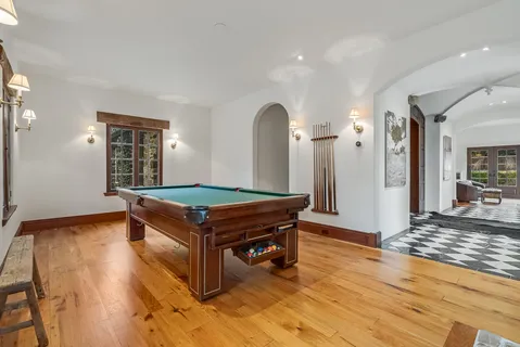 a bathroom with a granite countertop toilet sink and mirror