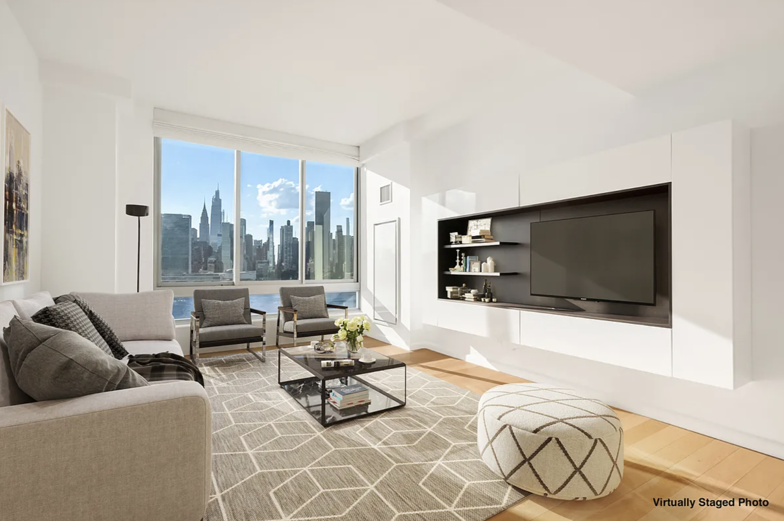 a living room with furniture a flat screen tv and a floor to ceiling window
