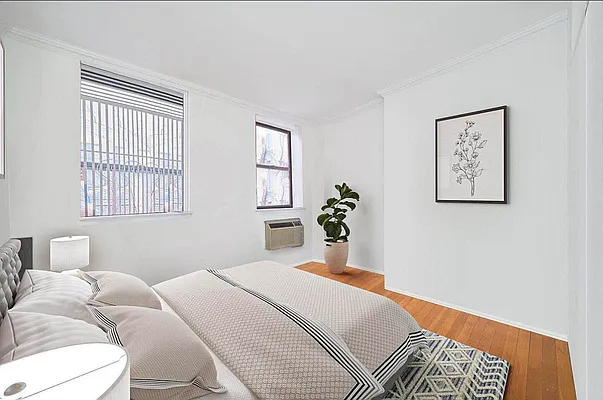103 West 105th Street, Unit 2B Manhattan, NY 10025 - Photo 3 of 9 a bedroom with a bed painting on wall and a window