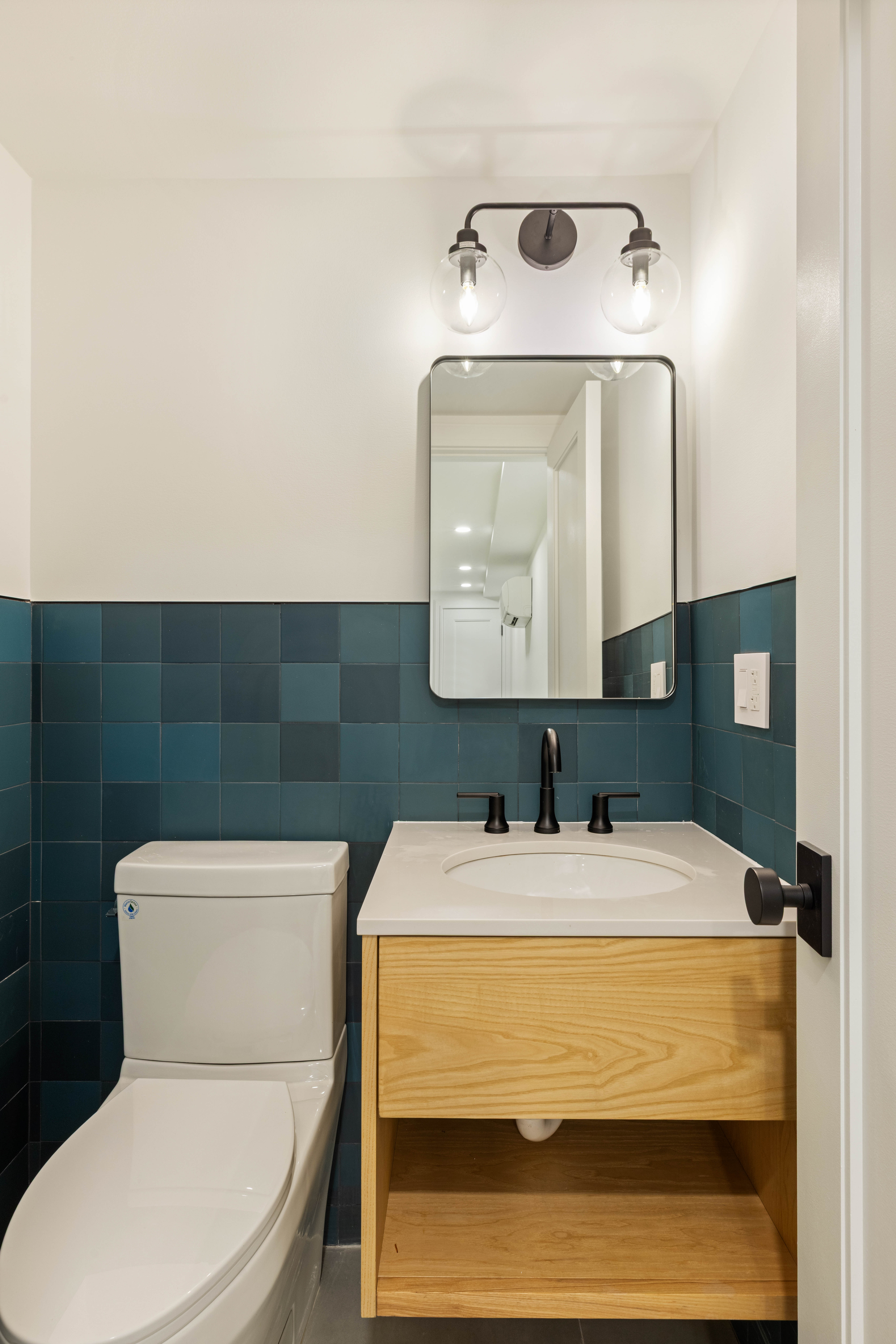 173 8th Street Brooklyn, NY 11215 - Photo 13 of 17 a bathroom with a toilet sink and mirror