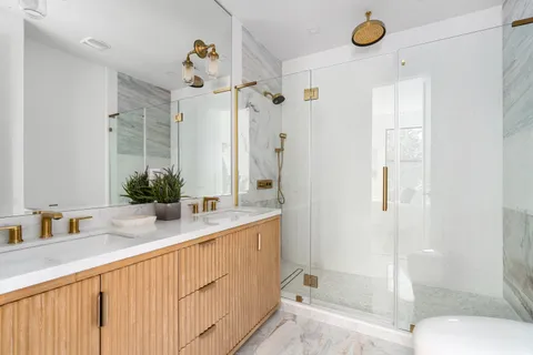 a bathroom with a shower sink and mirror