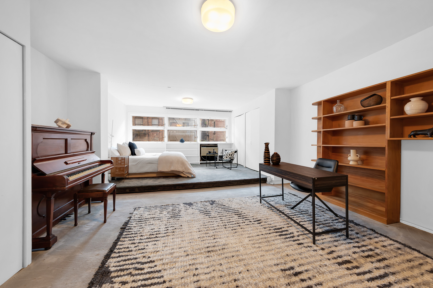 206 East 30th Street Manhattan, NY 10016 - Photo 10 of 17 a bedroom with furniture and a rug