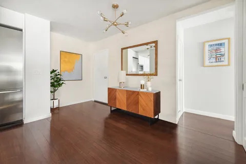 a room with wooden floor and a ceiling fan