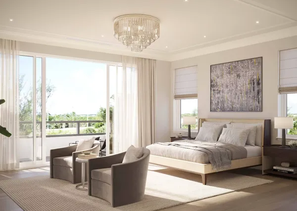 a bedroom with a large bed and a chandelier