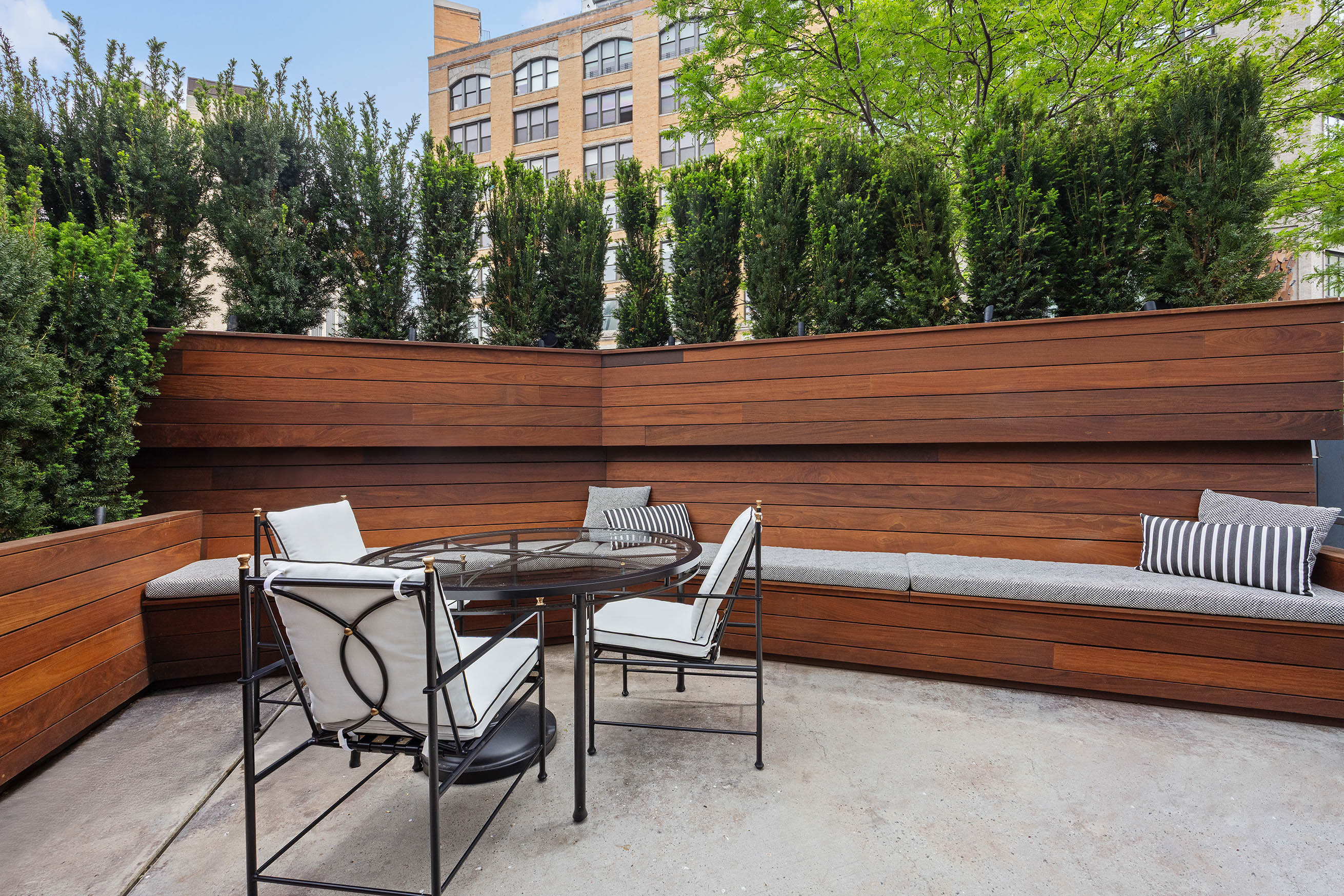471 Washington Street, Unit 1B Manhattan, NY 10013 - Photo 6 of 16 a backyard of a house with barbeque oven table and chairs