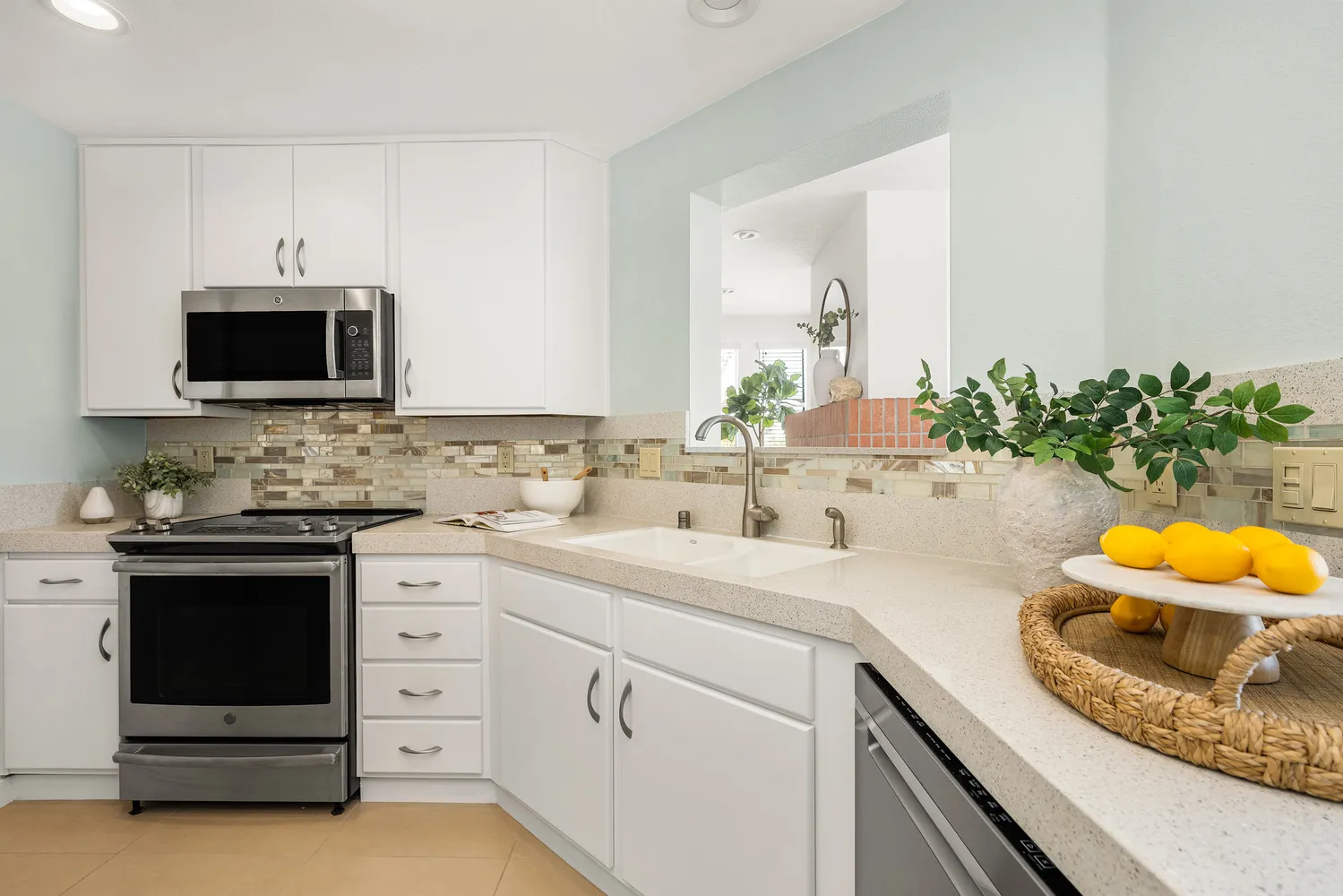 a kitchen with stainless steel appliances granite countertop a refrigerator a stove and a sink