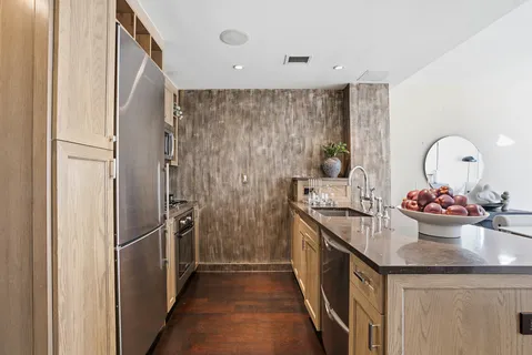 a kitchen with sink and refrigerator