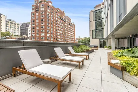a view of balcony with outdoor seating and city view