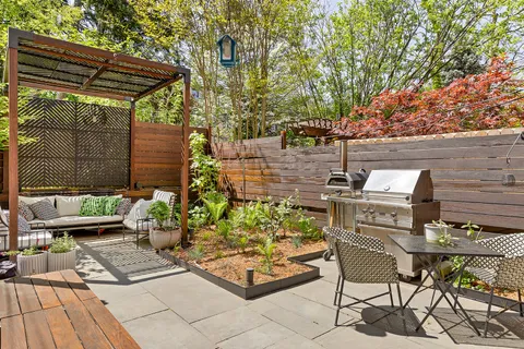 a view of a backyard with sitting area