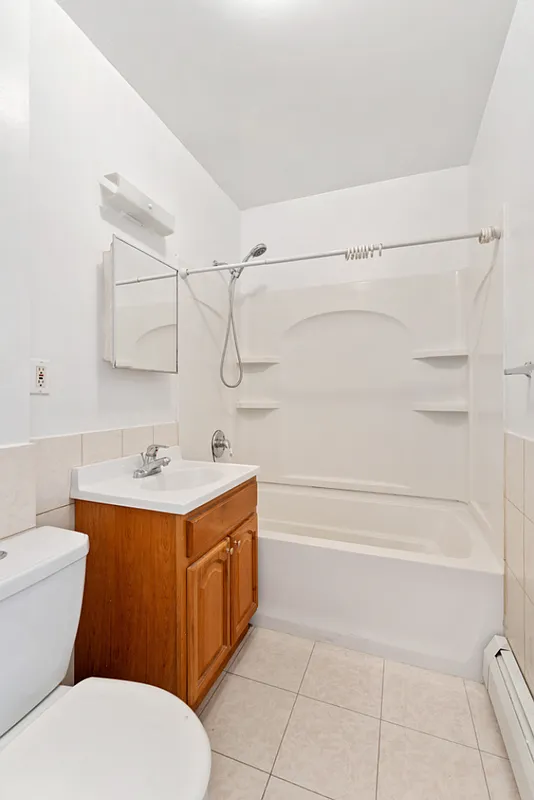 1402 Cortelyou Road, Unit 4 Brooklyn, NY 11226 - Photo 4 of 5 a bathroom with a sink a toilet and shower
