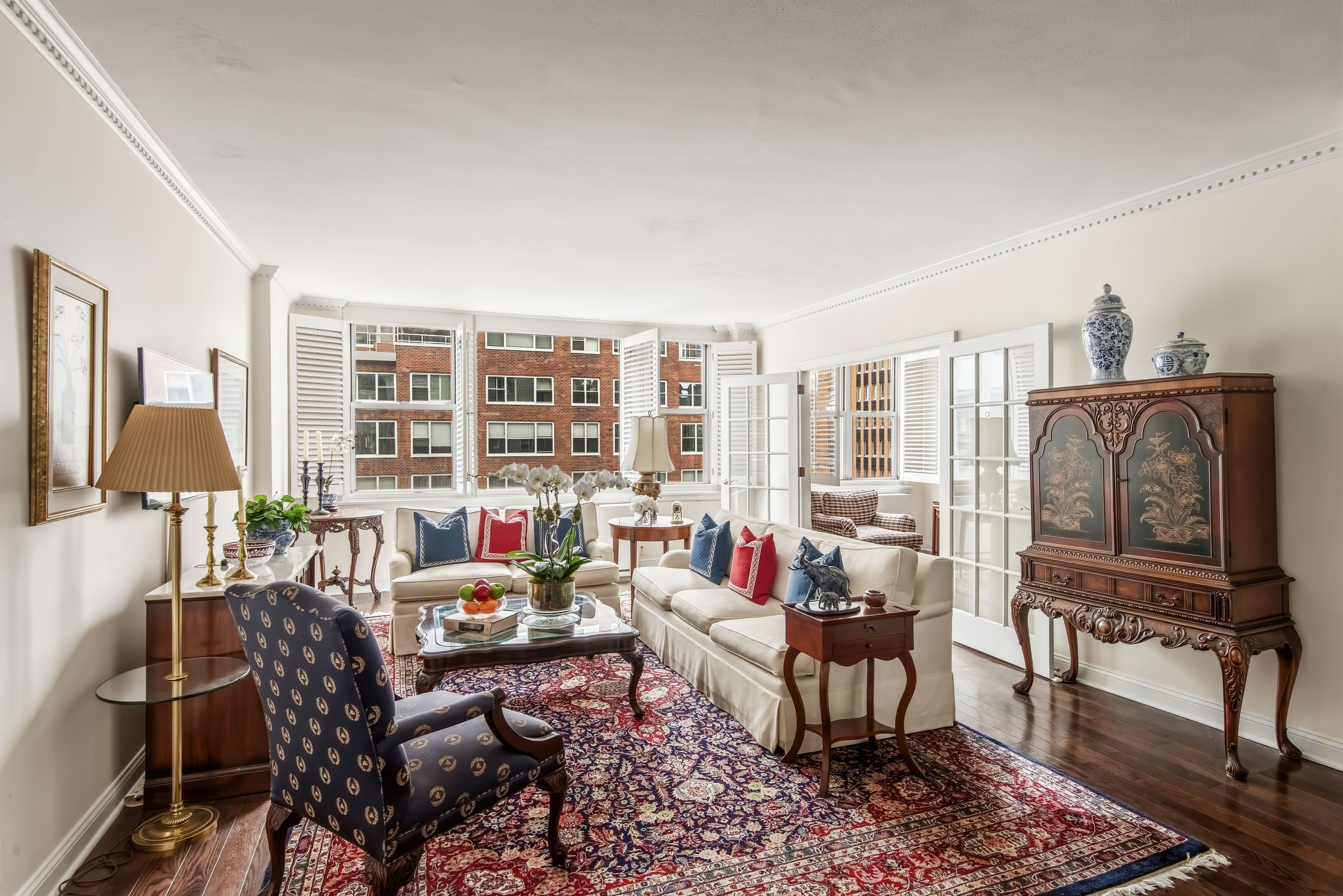 a living room with furniture and a floor to ceiling window