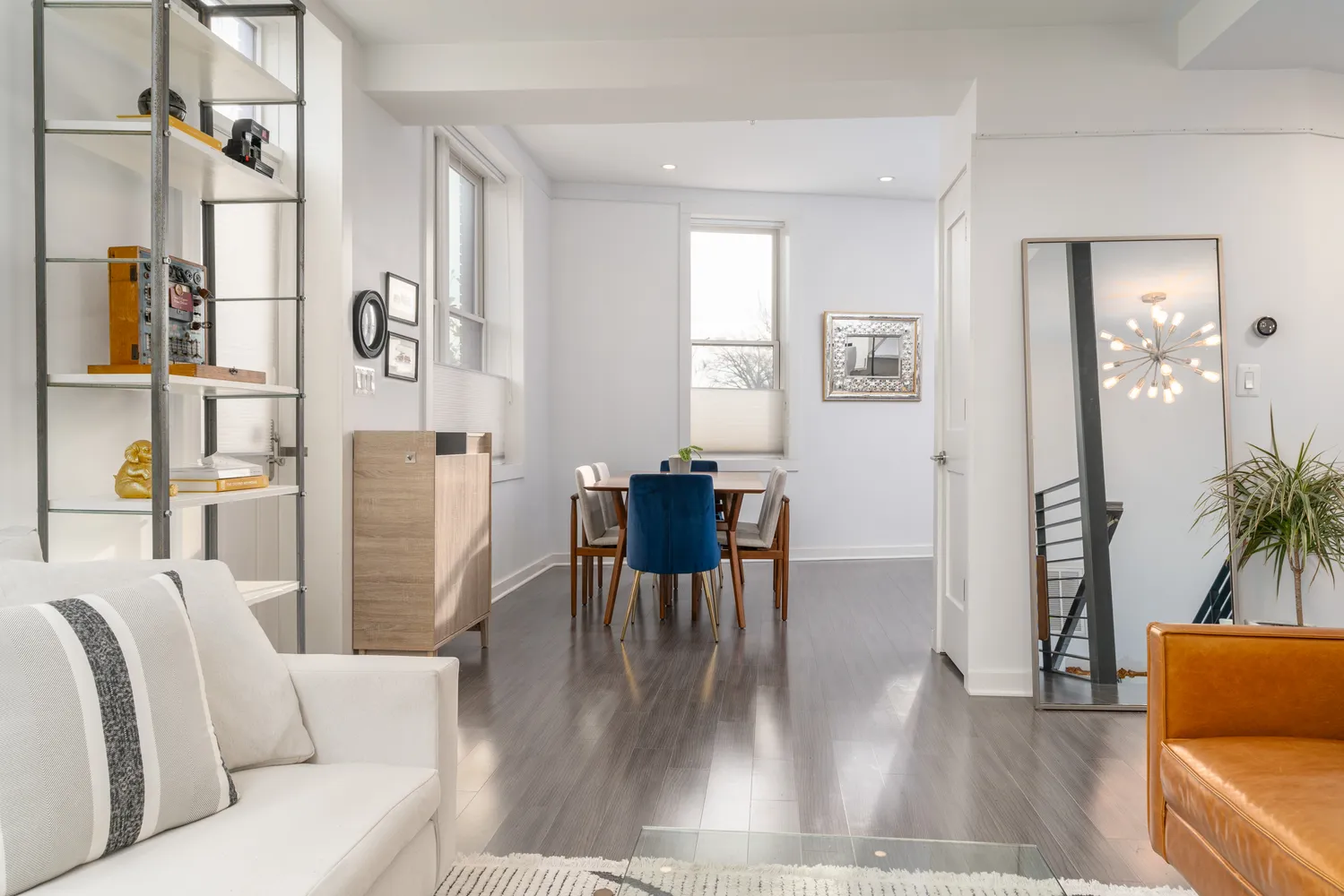 a living room with furniture wooden floor and a table