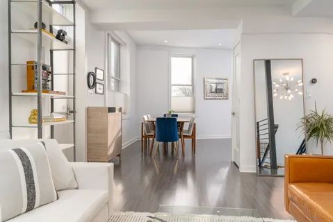 a living room with furniture wooden floor and a table