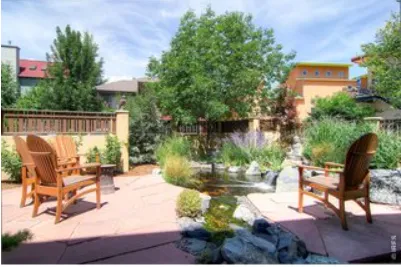 a view of a chairs and table in patio with a lake view