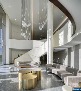 a living room with fireplace furniture and a chandelier