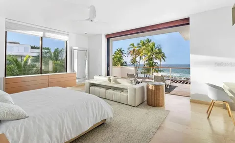 a bedroom with a large bed and a large window