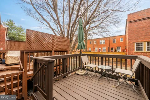 a view of balcony with wooden floor and outdoor seating