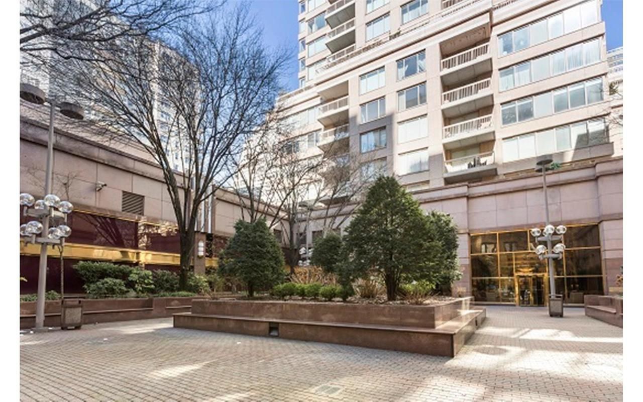200 East 69th Street, Unit 4N Manhattan, NY 10021 - Photo 12 of 13 a view of a building and car parked on the road