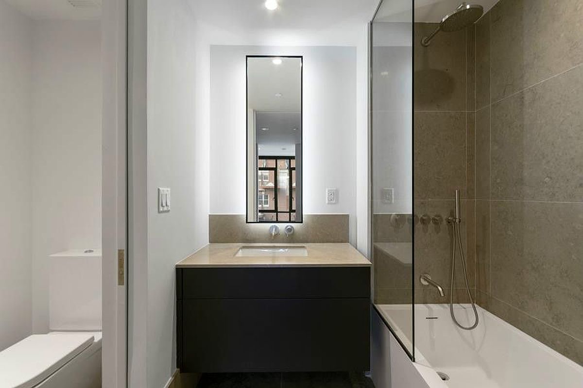 429 Kent Avenue, Unit 607 Brooklyn, NY 11249 - Photo 6 of 14 a bathroom with a sink a toilet and shower