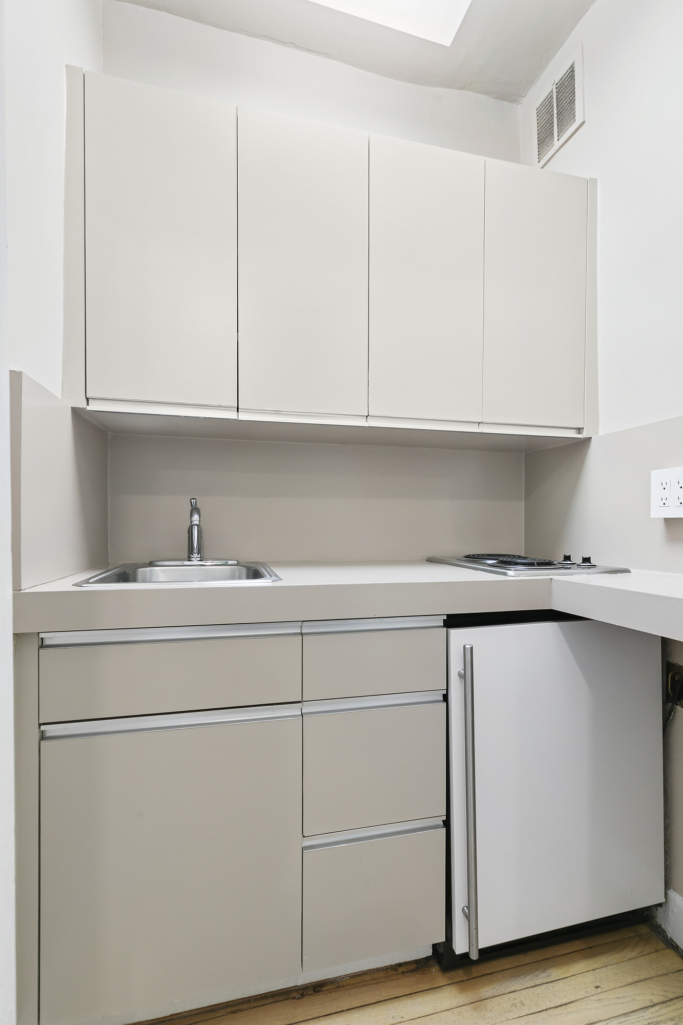 575 Park Avenue, Unit 1403 Manhattan, NY 10065 - Photo 10 of 15 a kitchen with a sink and cabinets