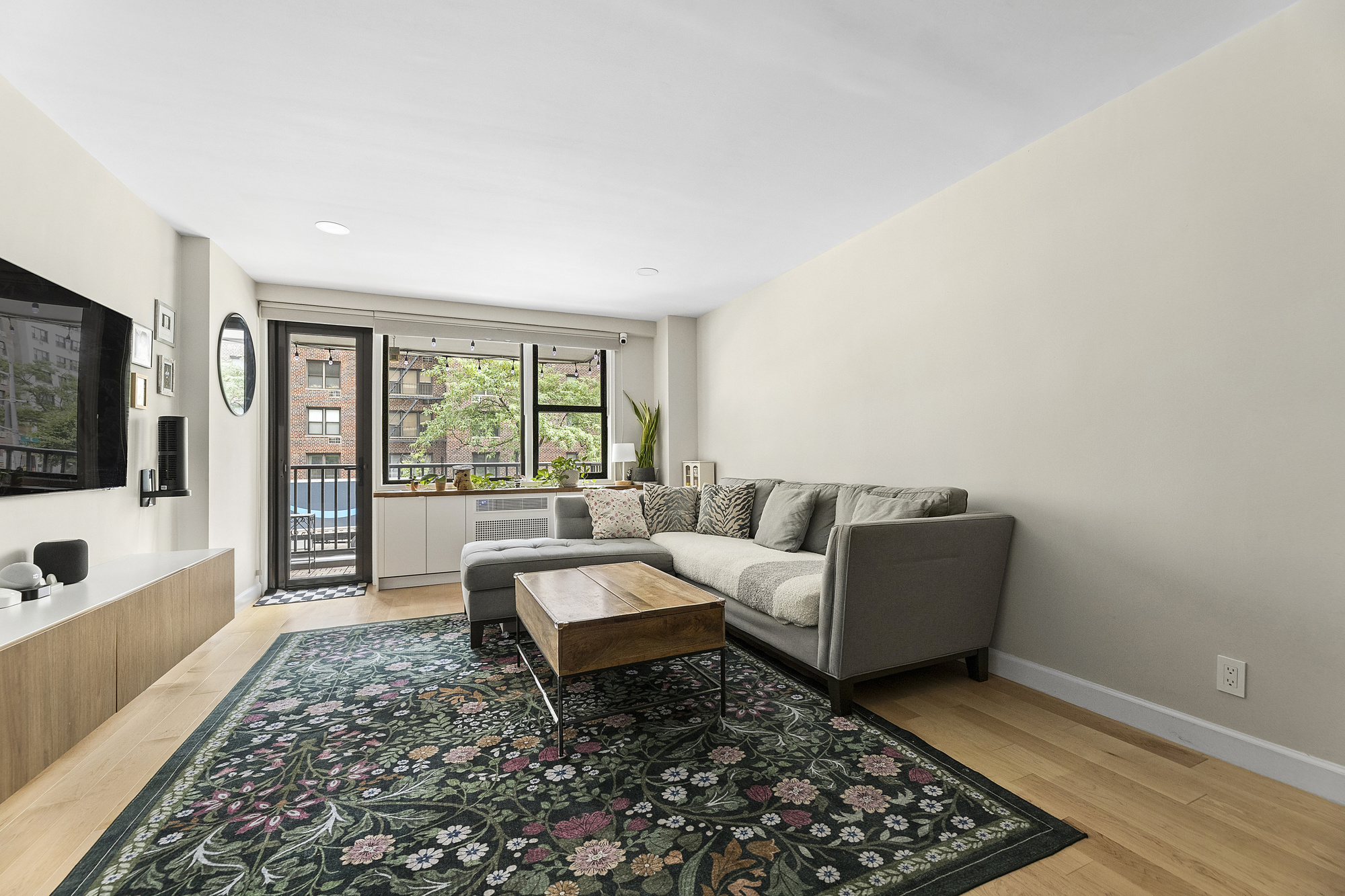 145 East 15th Street, Unit 2T Manhattan, NY 10003 - Photo 1 of 10 a living room with furniture and a rug