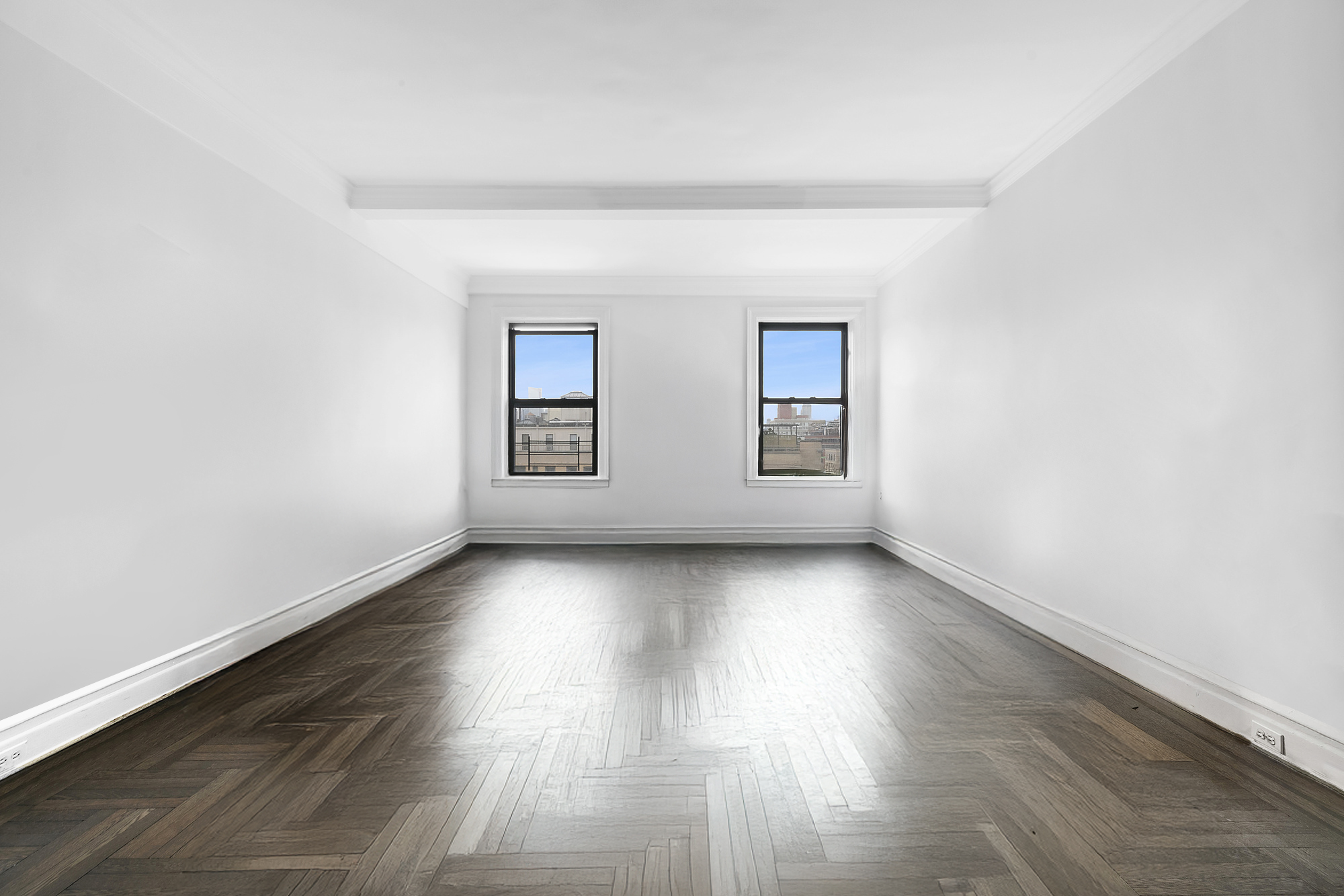 215 West 92nd Street, Unit 15A Manhattan, NY 10025 - Photo 4 of 14 an empty room with wooden floor and windows