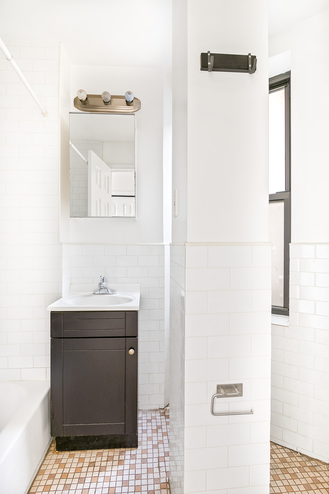 117 Henry Street, Unit 11 Manhattan, NY 10002 - Photo 4 of 4 a bathroom with a sink and a mirror