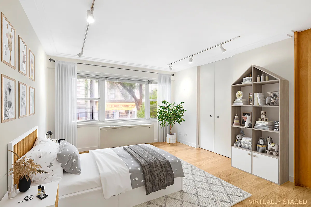 333 East 66th Street, Unit 2FE Manhattan, NY 10065 - Photo 9 of 19 a bedroom with a large bed and a window