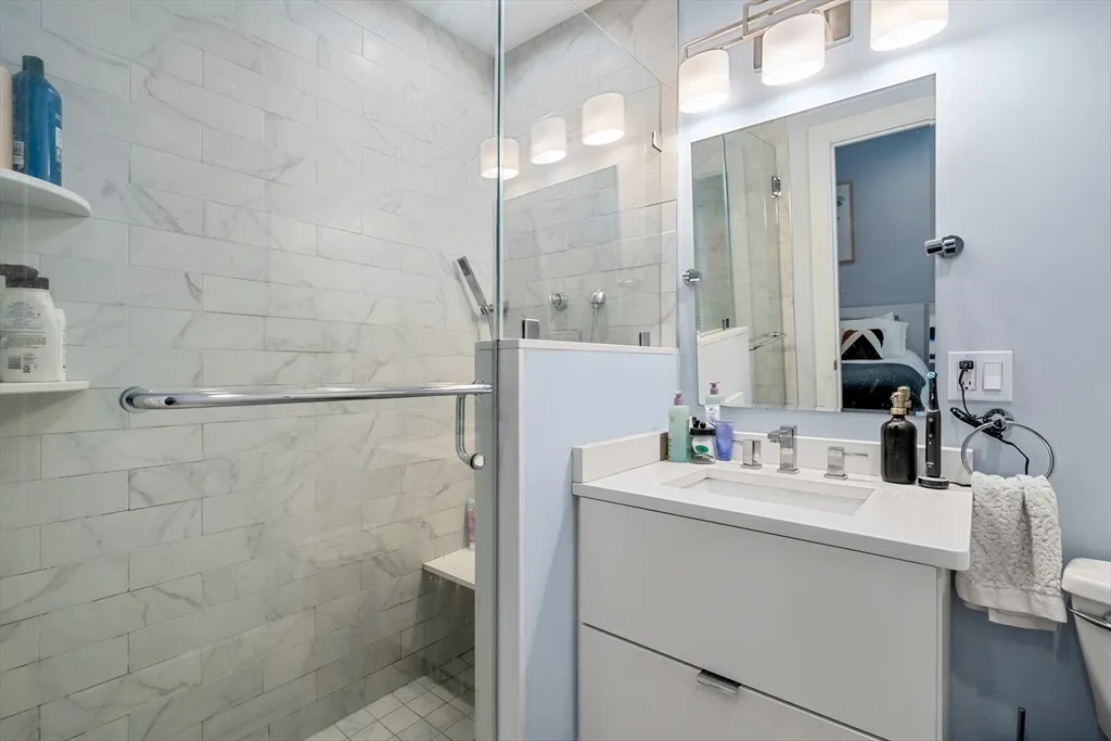 a bathroom with a sink vanity and a mirror