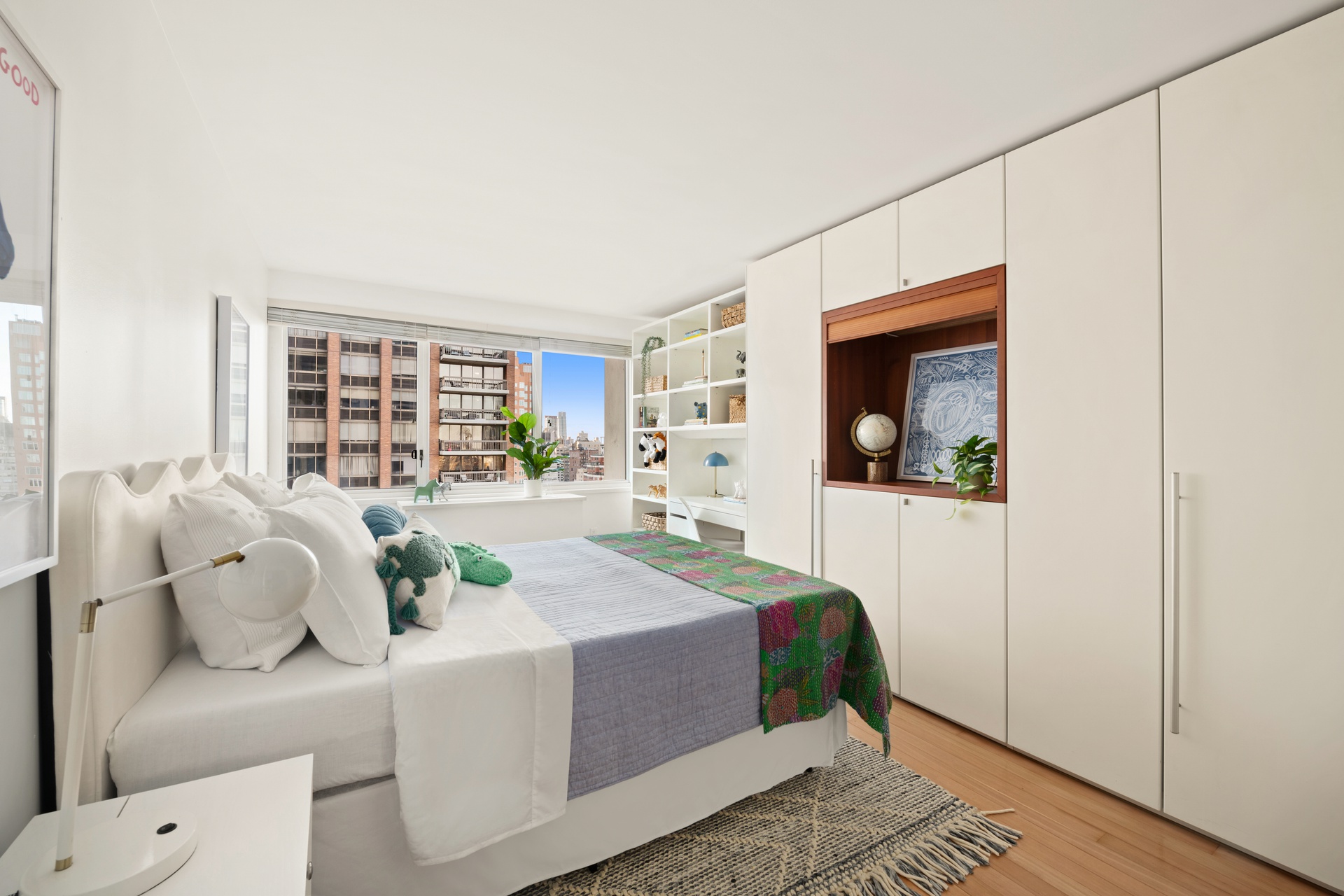 300 East 59th Street, Unit 2103 Manhattan, NY 10022 - Photo 10 of 14 a bedroom with a large bed and a window