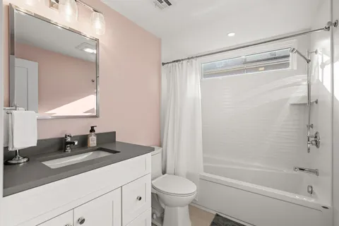 a bathroom with a sink a toilet and a bathtub