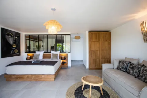 a living room with furniture and a chandelier