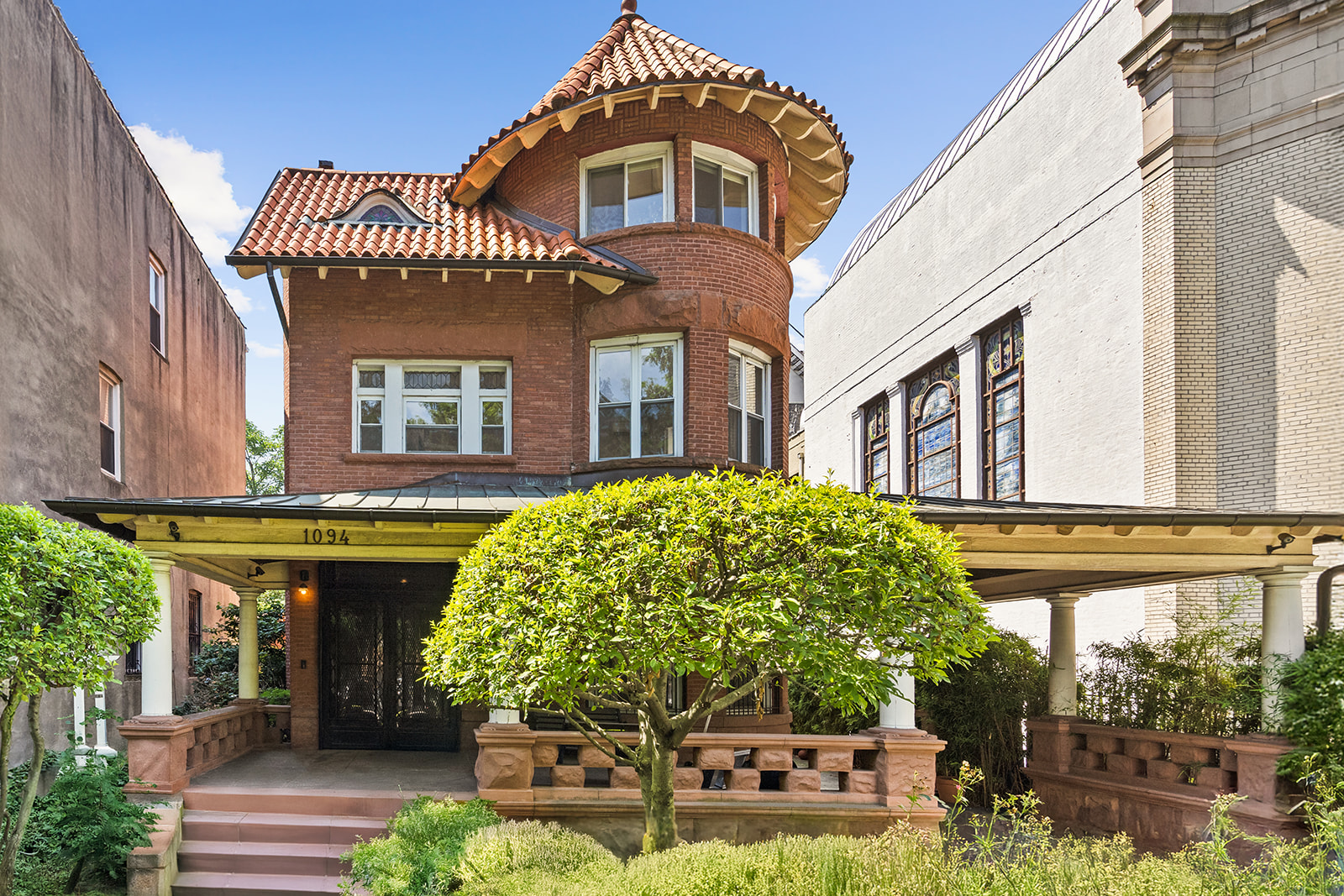 a front view of a house with garden
