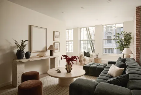 a living room with furniture and floor to ceiling windows