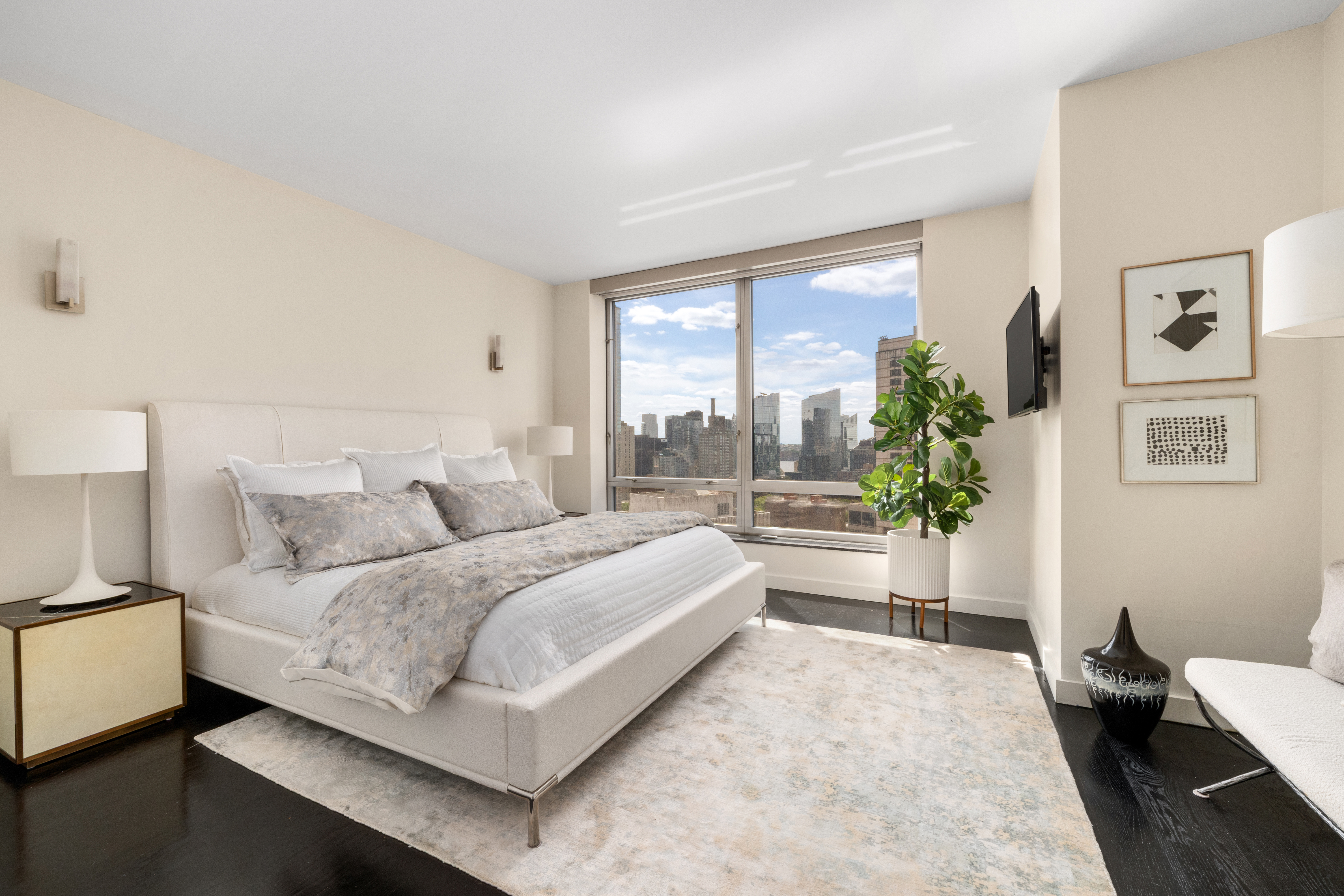 150 Columbus Avenue, Unit 22A Manhattan, NY 10023 - Photo 7 of 23 a bedroom with a large bed and a potted plant