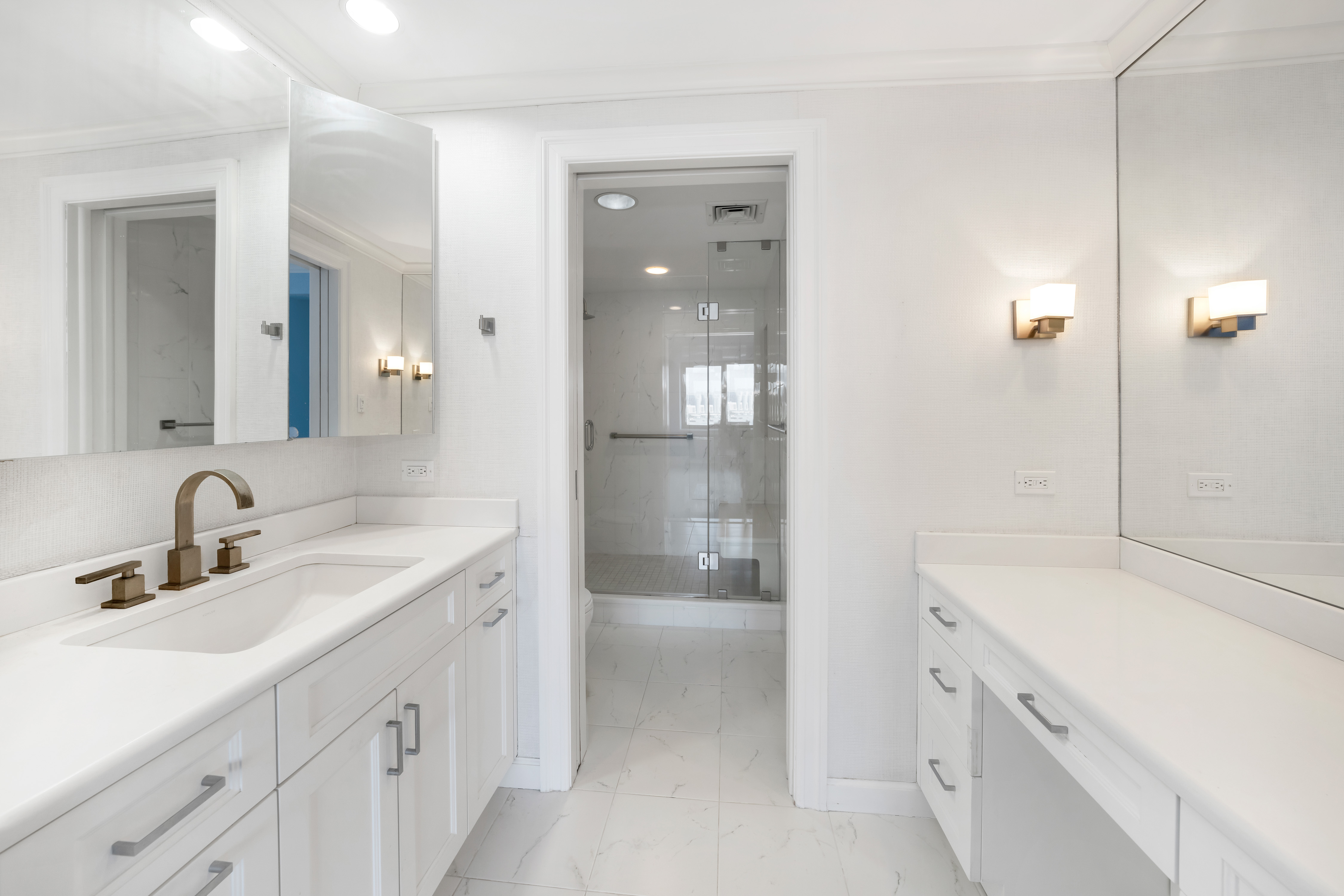 45 Sutton Place South, Unit 8L Manhattan, NY 10022 - Photo 10 of 22 a bathroom with a sink and a mirror