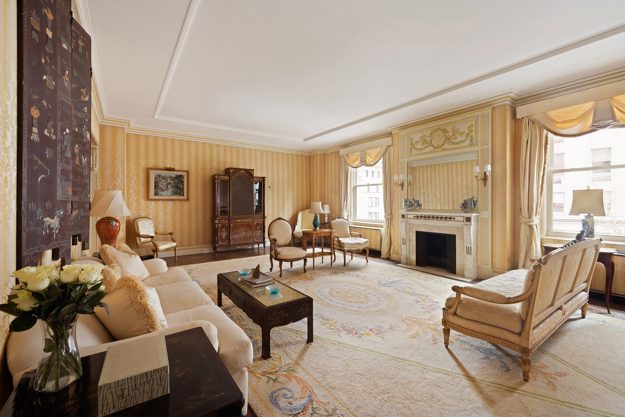 31 East 72nd Street, Unit 4B Manhattan, NY 10021 - Photo 2 of 14 a living room with furniture fireplace and a table
