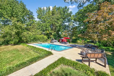 a view of a swimming pool with chairs