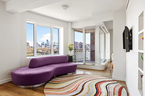 a living room with furniture and a floor to ceiling window