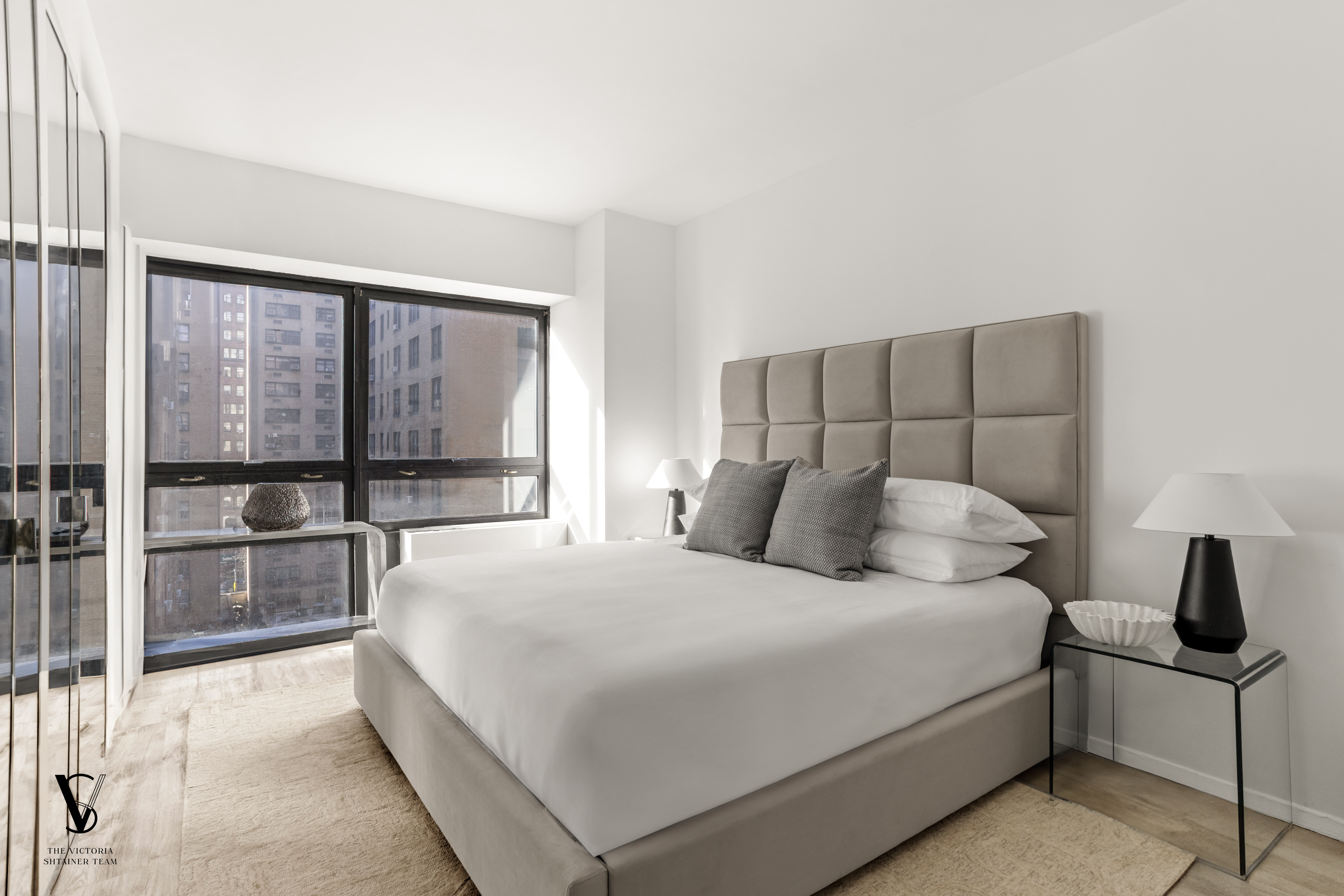 415 East 54th Street, Unit 6D Manhattan, NY 10022 - Photo 10 of 18 a bedroom with a large bed and a large window
