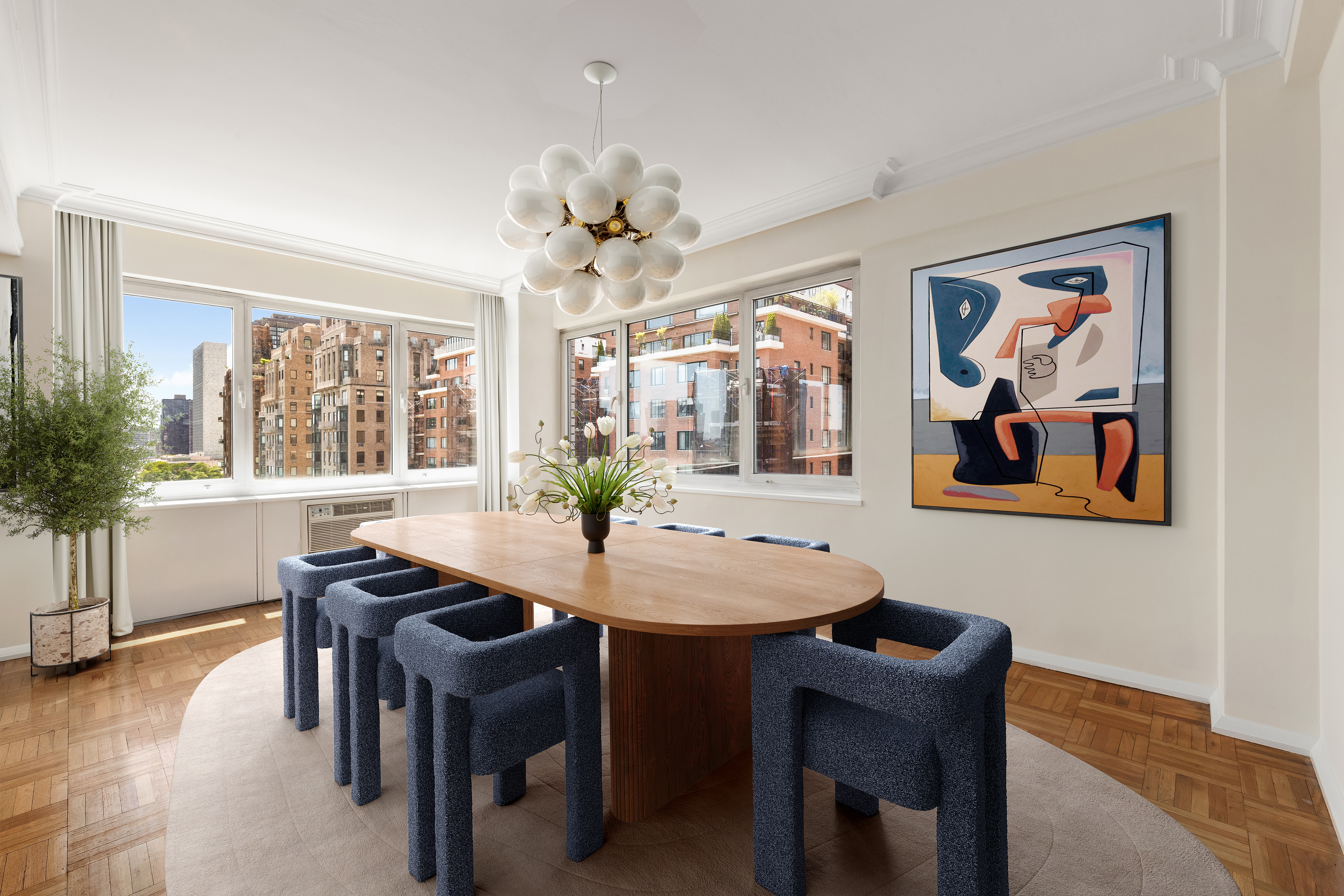 45 Sutton Place South, Unit 14N Manhattan, NY 10022 - Photo 3 of 19 a view of a dining room with furniture window and wooden floor