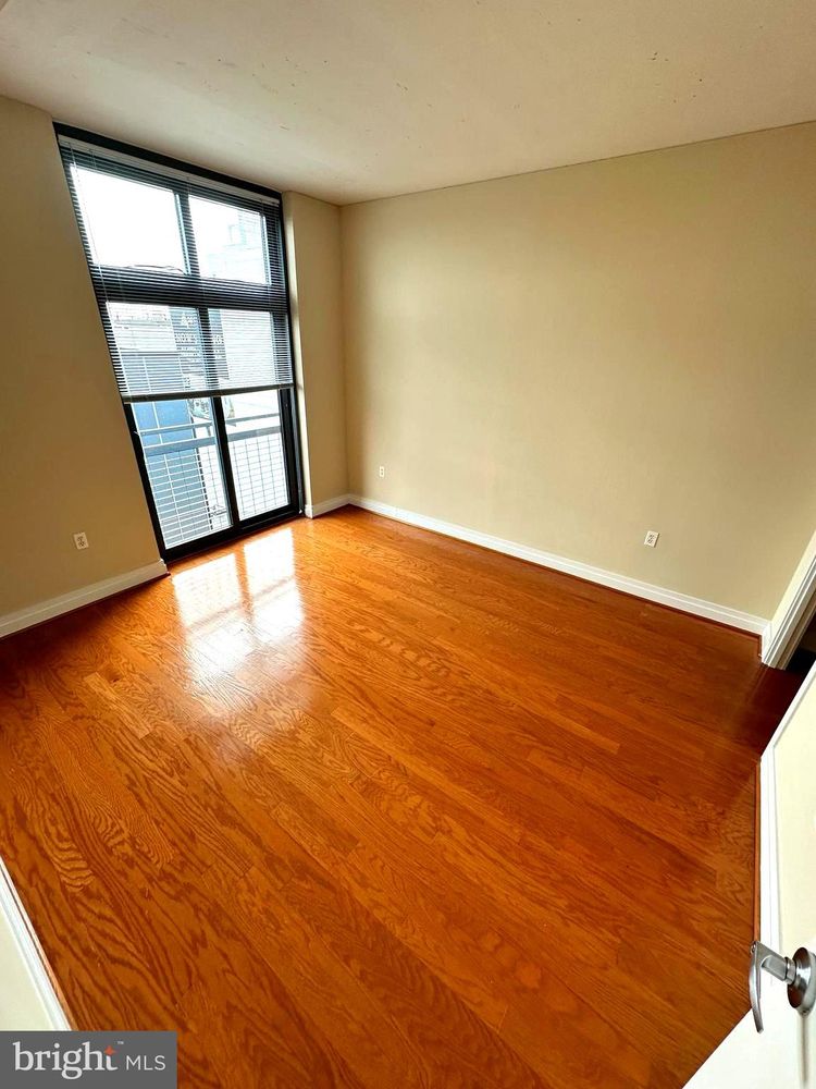 2120 Vermont Avenue Northwest, Unit 620 Washington, DC 20001 - Photo 10 of 61 wooden floor in an empty room with a window