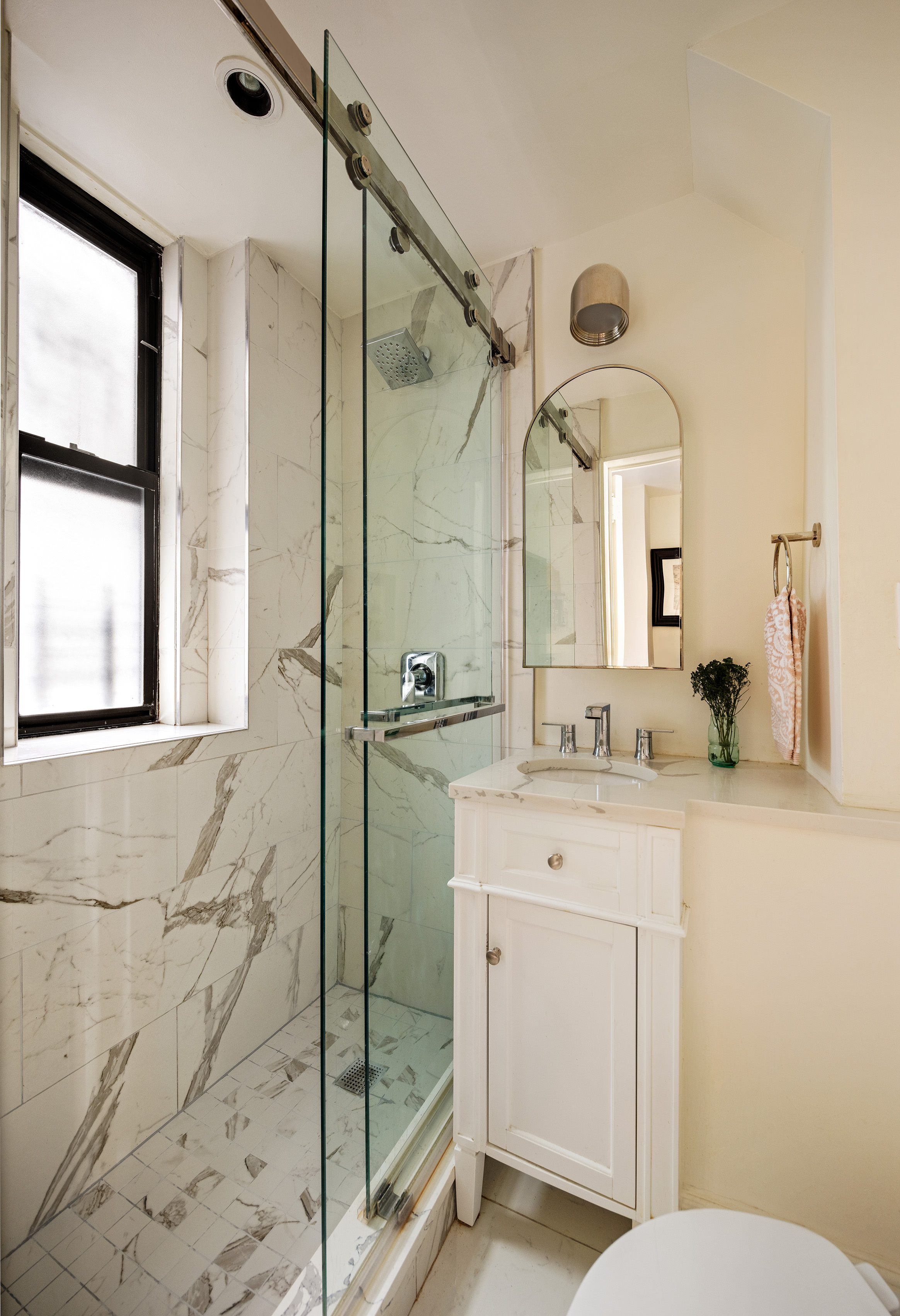 114 East 84th Street, Unit 3C Manhattan, NY 10028 - Photo 12 of 15 a bathroom with a sink a mirror a toilet and shower