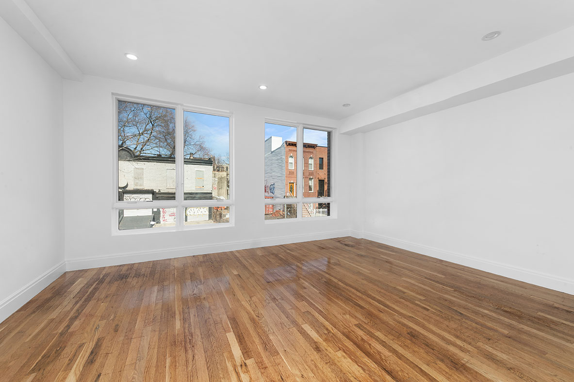 686 MacDonough Street, Unit 2A Brooklyn, NY 11233 - Photo 1 of 8 a view of an empty room with wooden floor and a window
