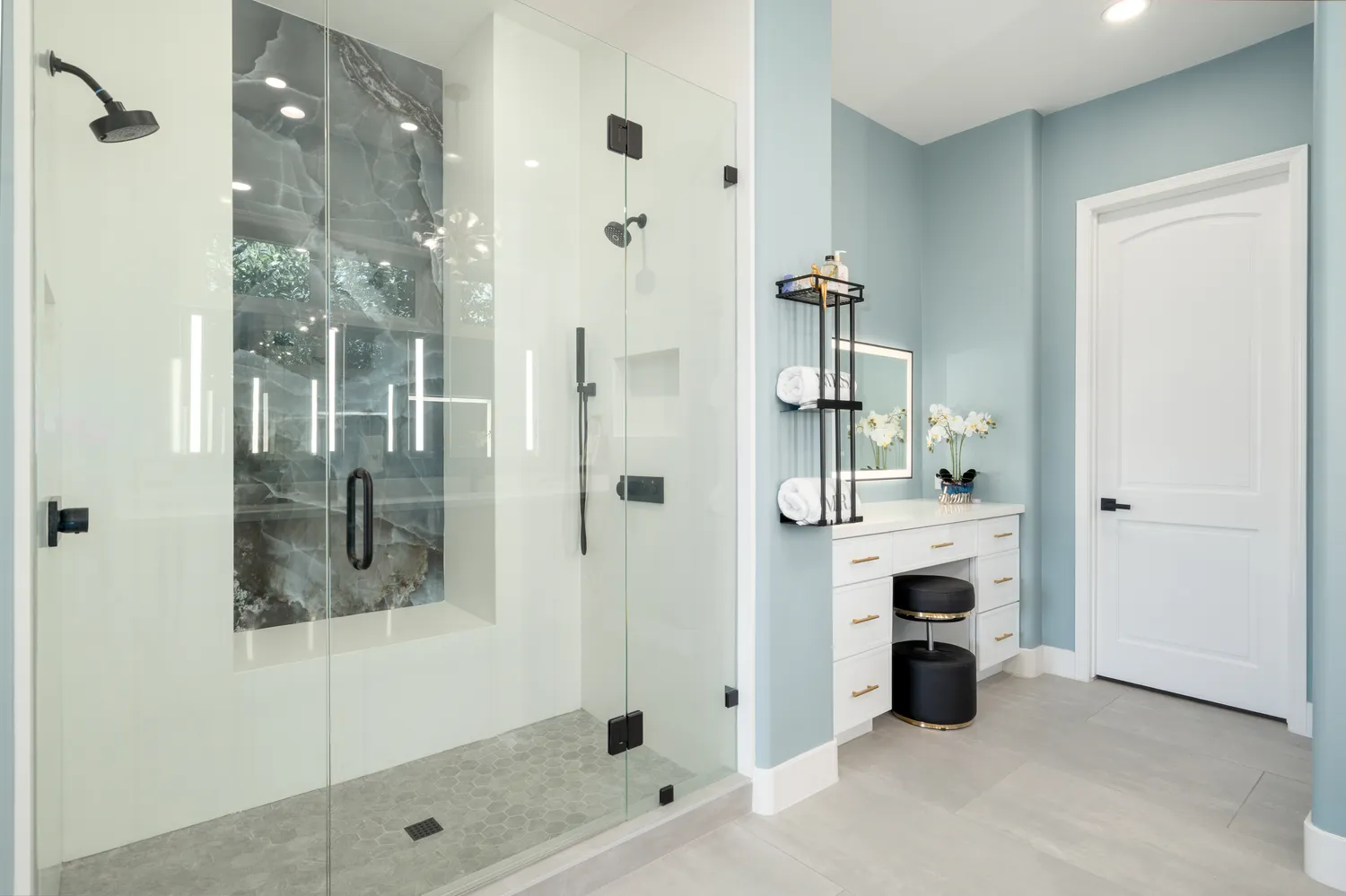 a bedroom with furniture a flat screen tv and a large window