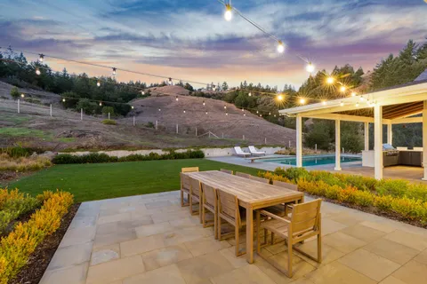an outdoor space with furniture and garden