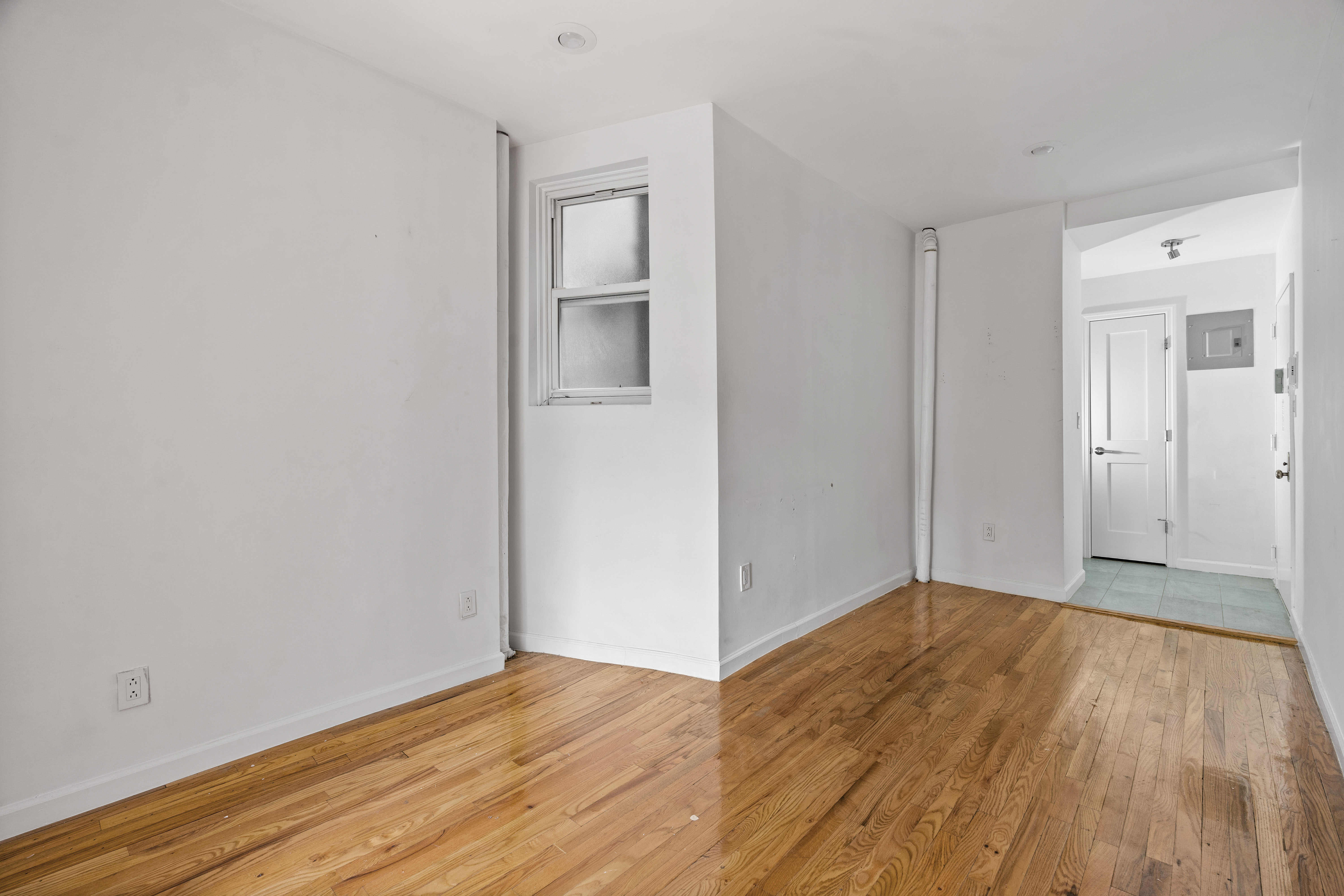 746 9th Avenue, Unit 4DF Manhattan, NY 10019 - Photo 6 of 13 a view of an empty room with wooden floor